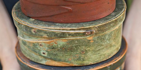stack of shaker pantry boxes with original paint in rust and green colors