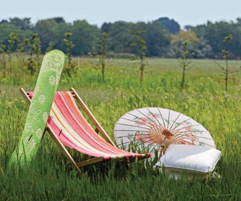striped sling chair, green run, parasol and pillows