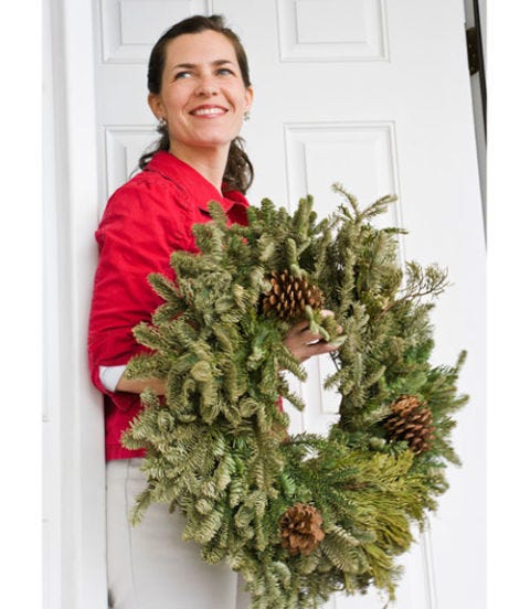 serena thompson with a holiday wreath