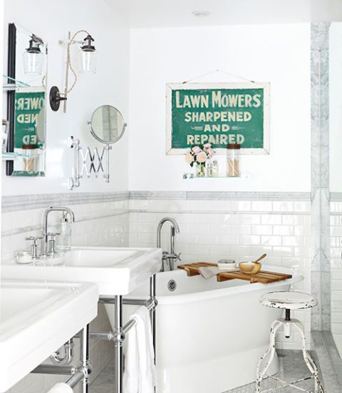 white master bathroom with an antique sign for decor