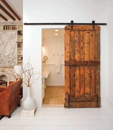 white bathroom with sliding wood door