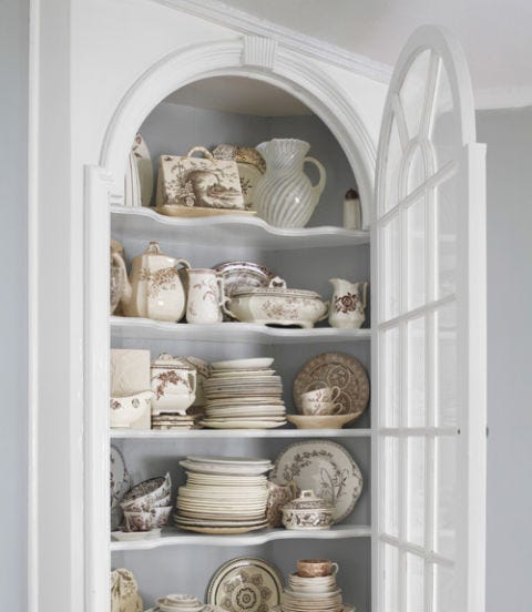display of antiques in a white dining room