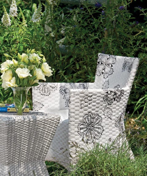 white wicker armchair and end table
