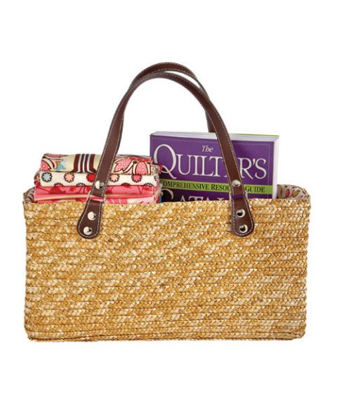 straw purse with quilting items inside