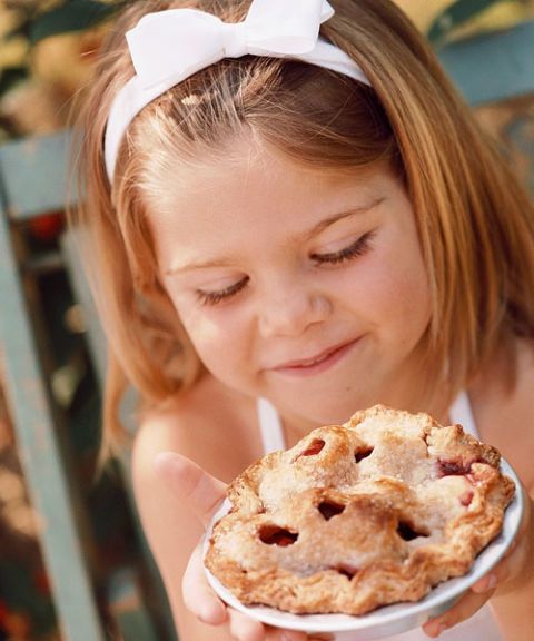 little girl with mini fruit pie