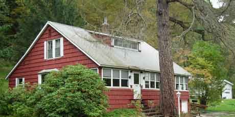 red house before roof construction begins