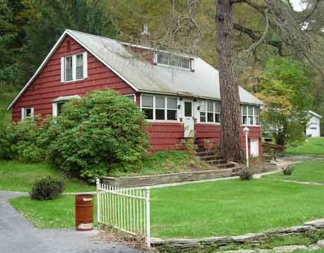 red house before roof construction begins