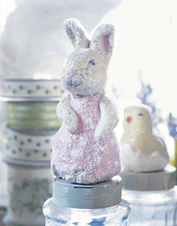 papier mache sparkly bunny figure and chick in shell on top of jars
