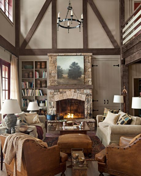 traditional living room with a stone fireplace and couches and leather chairs