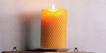 beeswax rolled candle on pedestal