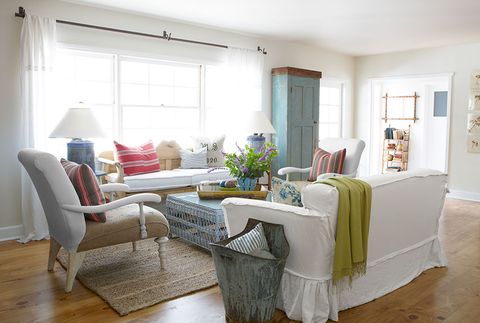 living room with white slipcover sofas and colorful pillows