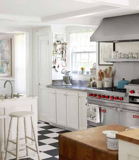 white kitchen with black and white tile floor