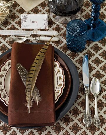 place setting with pheasant feathers