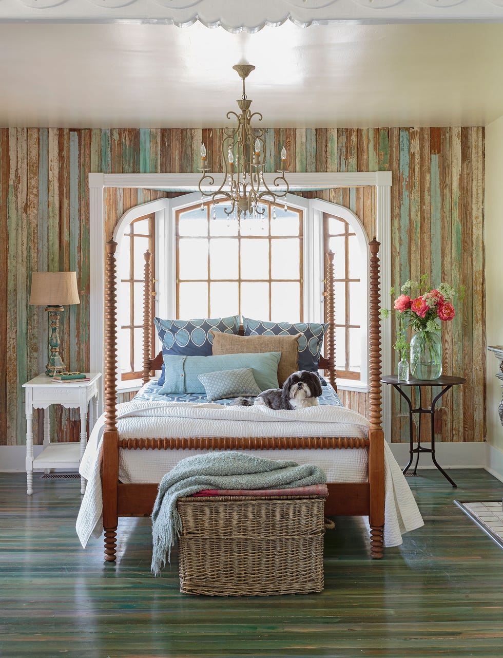 bedroom with spool bed and beaded chandlier