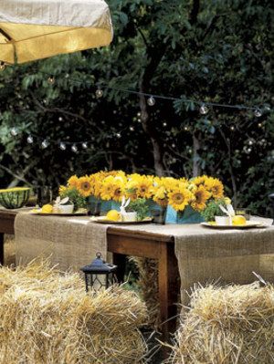 table set outdoors with bales of hay