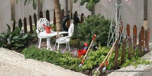 Plant, Outdoor furniture, Shrub, Garden, Home fencing, Yard, Armrest, Lawn ornament, Landscaping, 