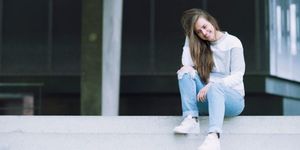 Jeans, Denim, Street fashion, Sitting, Knee, Flash photography, Sneakers, Long hair, Brown hair, Portrait photography, 