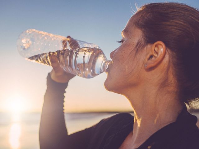 Vrouw drinkt water uit flesje