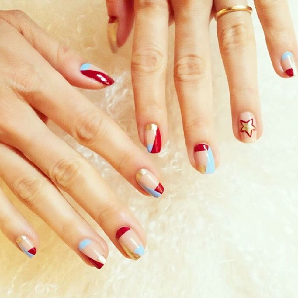 <p>Start with a sheer base then alternate cyan, red or gold to the half moon or tips with a diagonal color across. Keep your ring finger as the accent nail with an outlined gold star. </p><p>Design by <a class="_4zhc5 _ook48" title="misspopnails" href="https://www.instagram.com/p/BEcnH0AEd6Z/" target="_blank">@misspopnails</a><br></p>