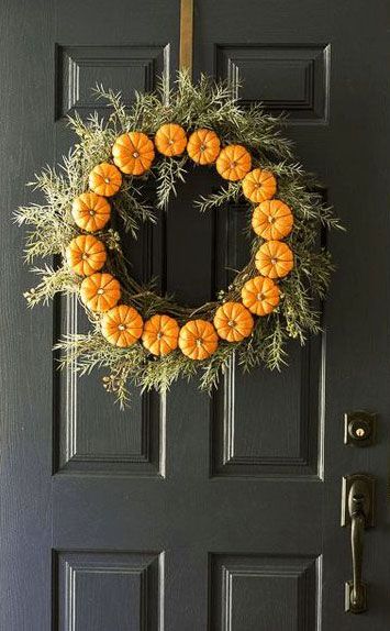 Wreath, Orange, Home door, Door, Door handle, Symmetry, Craft, Body jewelry, Natural material, Still life photography, 