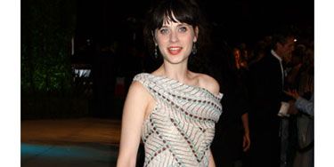 Zooey complements a busy geometric dress with a simple clutch.
