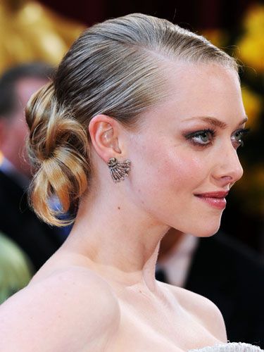 Rocking a deep side part and neat, low chignon, the <i>Dear John</i> actress kept the focus on her flawless face.