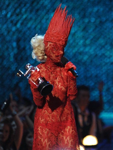 When she wore a full-length red lace dress, mask, and matching