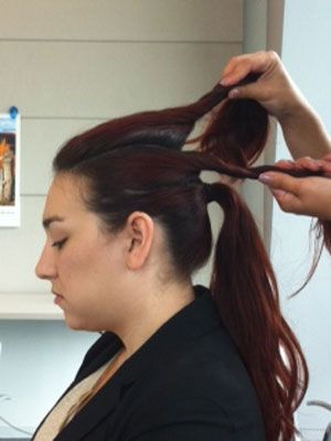 <p>Part your hair into three sections as shown. Brush the bottom section into a ponytail.</p>