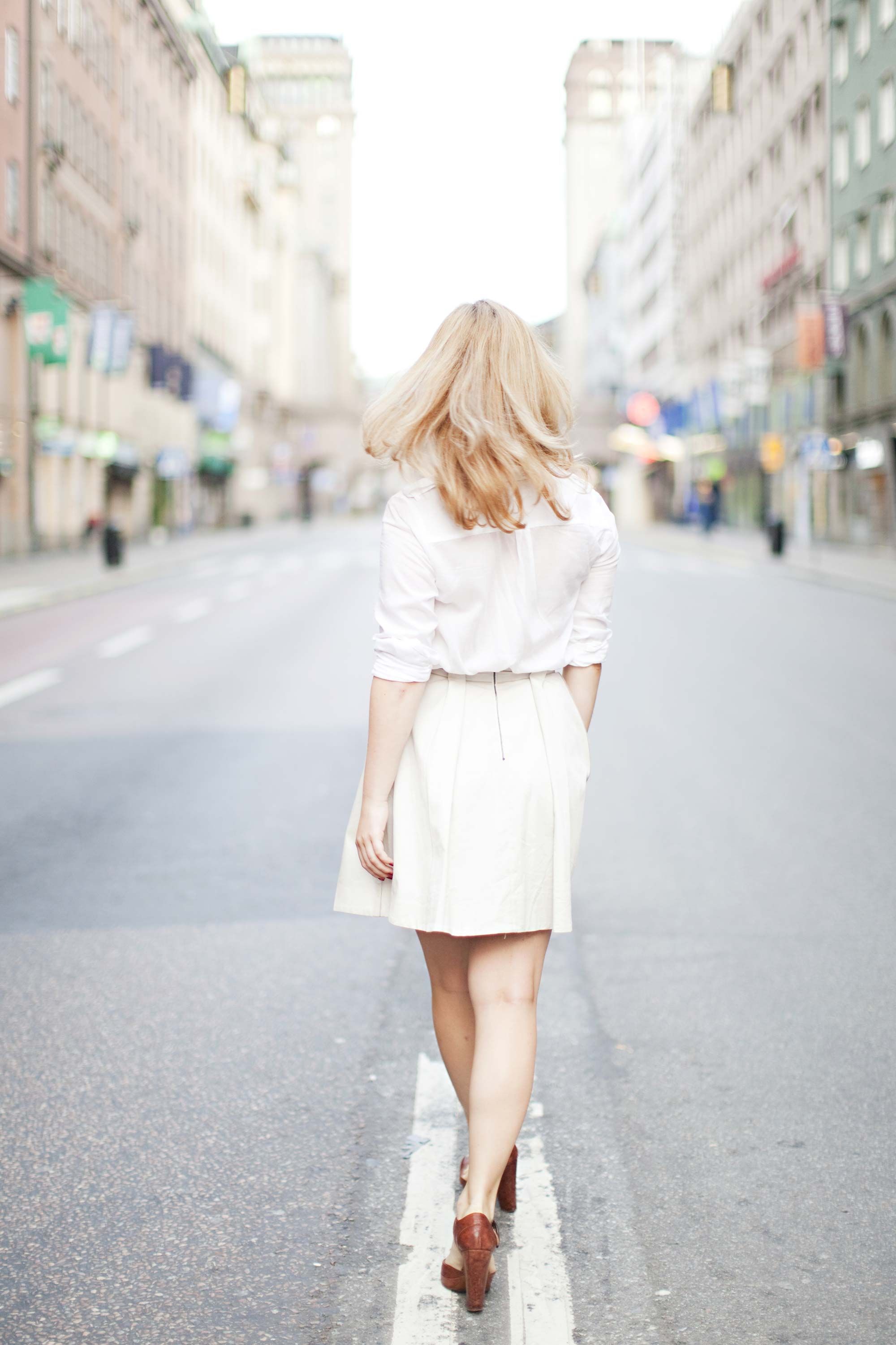 Girl in white skirt walks with her lucky boyfriend