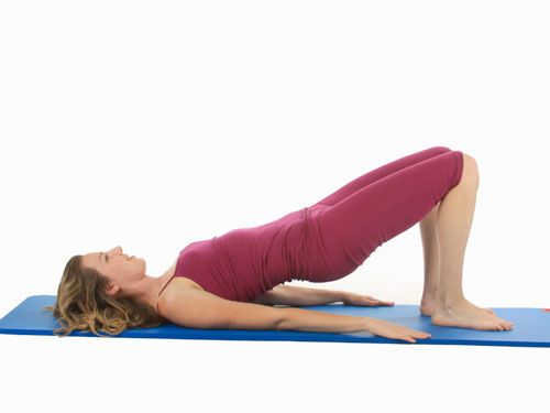 Get into bridge position, and lift your feet up and down, alternating left and right, like you’re marching. Complete two sets of six.