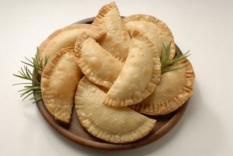 <p>8 oz. package of cream cheese spread<br />8 oz. package of guava paste<br />10 prepared empanada dough discs<br />Oil for frying<br /><br /></p>
<p>Lay one prepared dough disc onto a lightly floured counter top.<br />Place one tablespoon of cream cheese and one tablespoon of guava paste on the circle of dough. Keep it centered; do not go all the way to the edge.<br />Fold the dough over into a a half circle shape and crimp the edges with a fork. If the edges won't stay sealed you can dip the fork in water before crimping or use an egg wash.<br />Fry the filled empanadas at 360 degrees for 1 to 2 minutes per side. They should be lightly golden. Drain on paper towels.<br /><br /></p>
<p><em>Source: About.com</em><br /><br /></p>