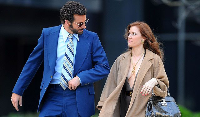 Amy Adams goes braless in a low-cut dress as Bradley Cooper sports springy  curls while pair film new movie