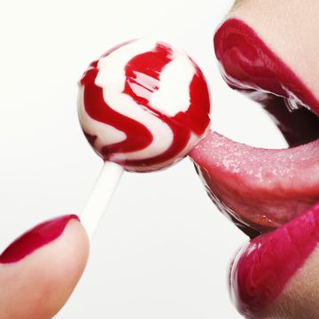 woman licking a lollipop