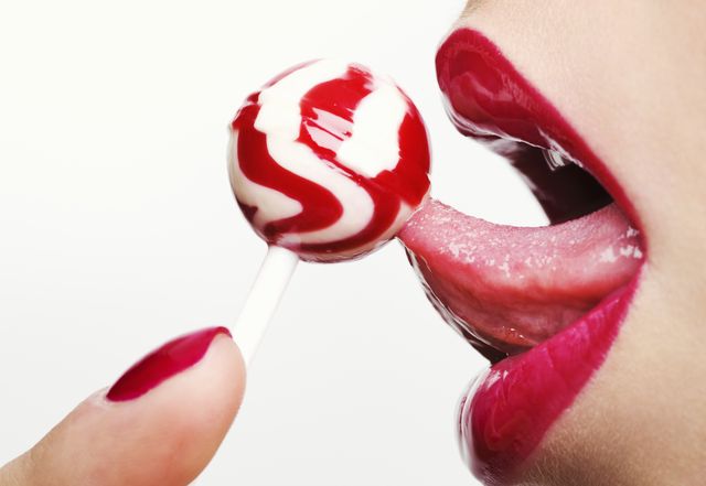woman licking a lollipop