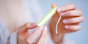 woman holding  tampon