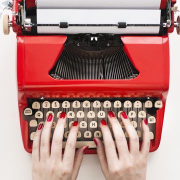 Woman typing on typewriter