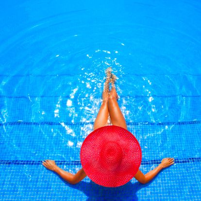 Woman sunbathing in swimming pool