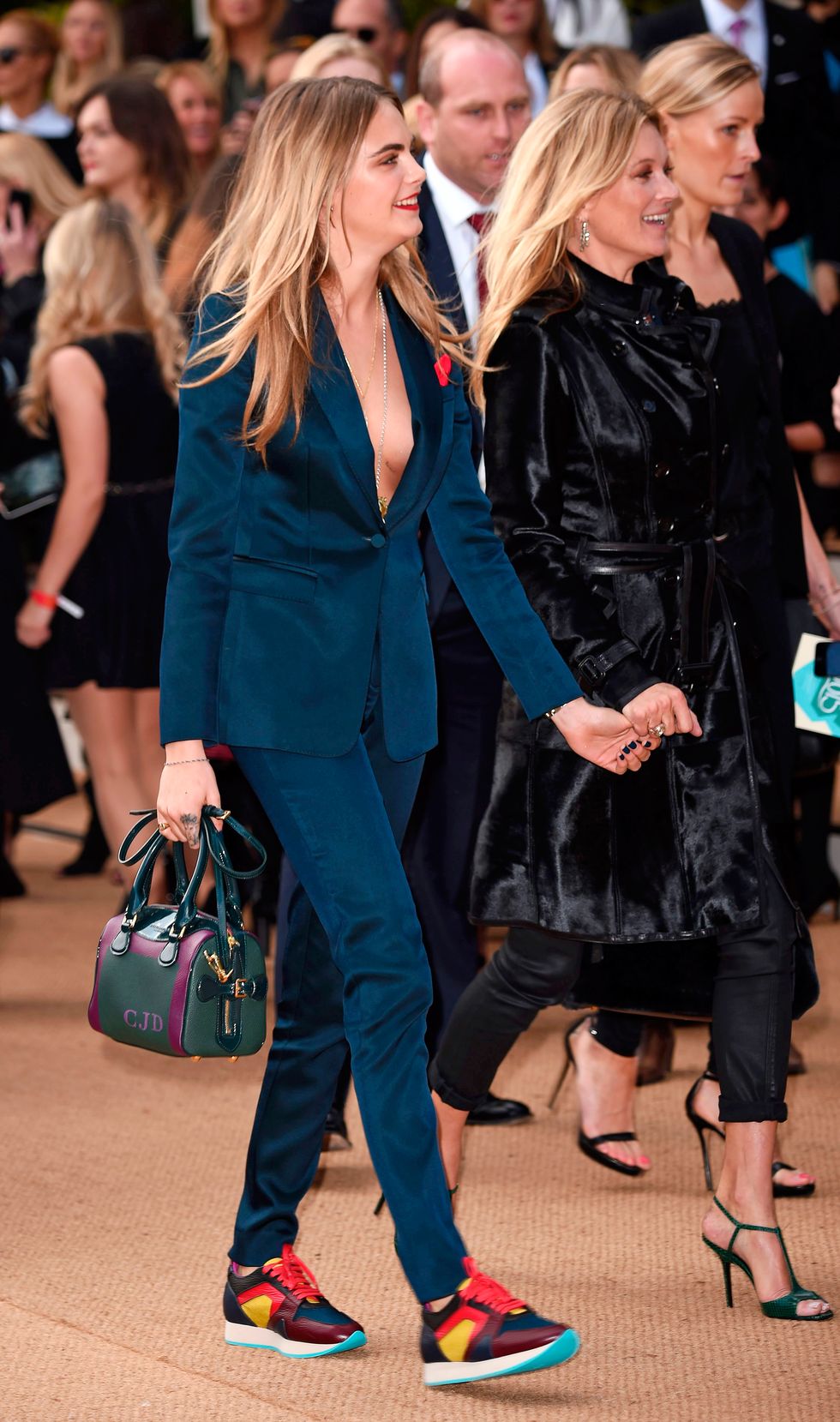 Cara Delevingne and Kate Moss holding hands at Burberry SS15