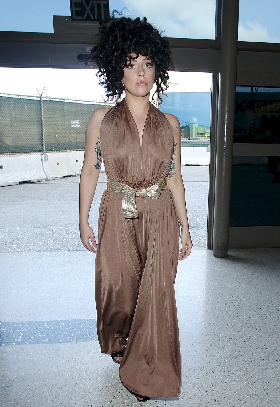 Lady Gaga in a brown jumpsuit at the airport