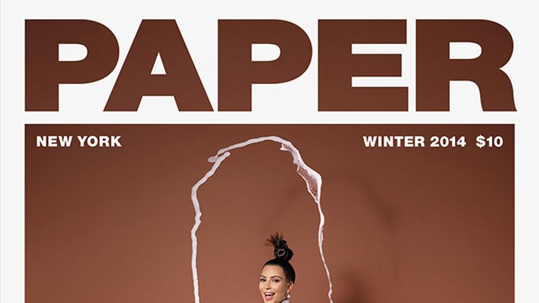 Kim Kardashian balances a champagne glass on her bum for Paper magazine
