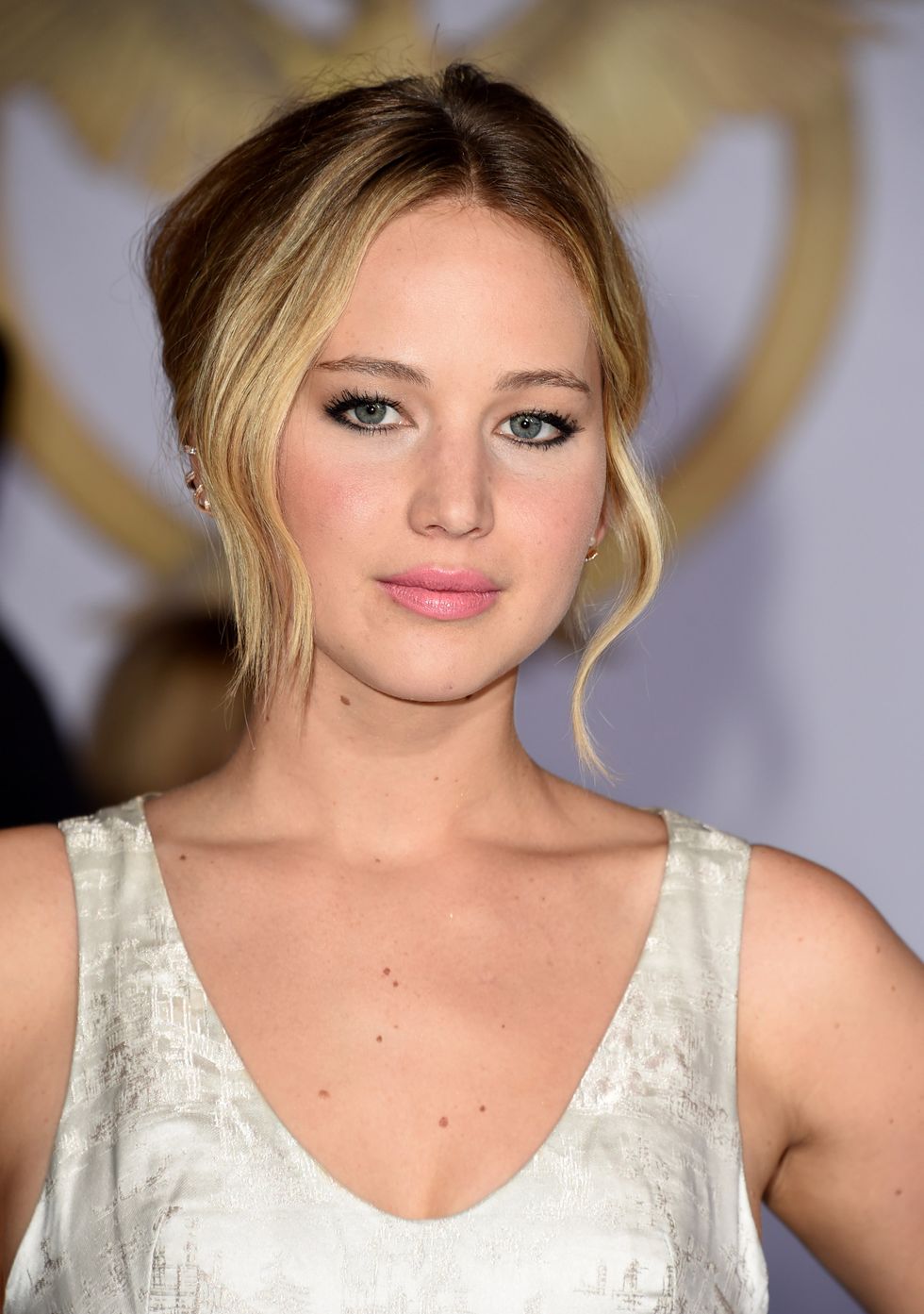 Jennifer Lawrence wears a sleeveless white Dior gown to the LA premiere of Mockingjay