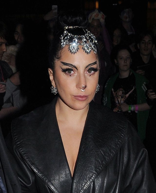 Lady Gaga with statement eyebrows and a silver headpiece in London
