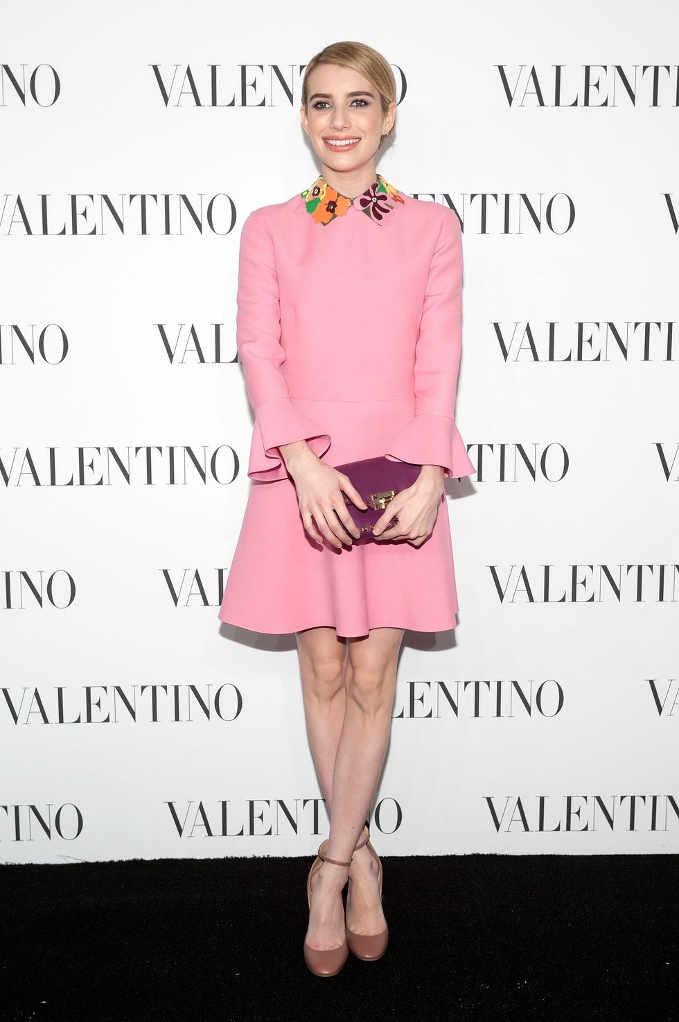 Emma Roberts wearing pretty pink mini dress to Valentino event