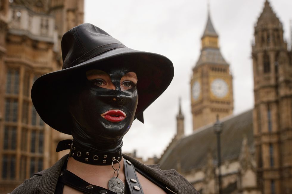 woman wears mask to porn protest outside parliament