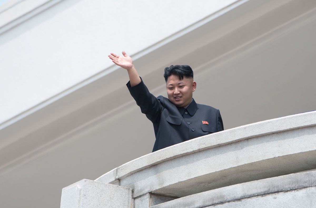 Kim Jong Un waves from a balcony
