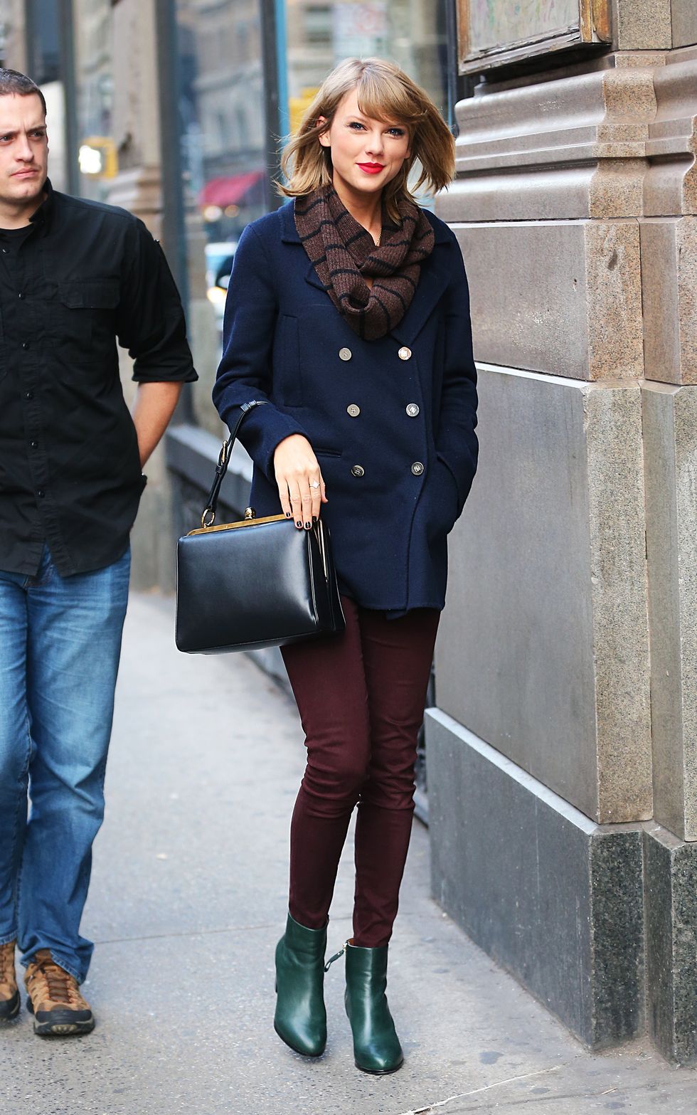 Taylor Swift wears a lovely navy blue coat while walking around in New York.