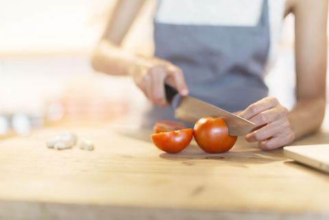 Chopping tomatoes with a kitchen knife