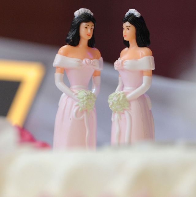 A pair of wedding-cake toppers in the shape of brides