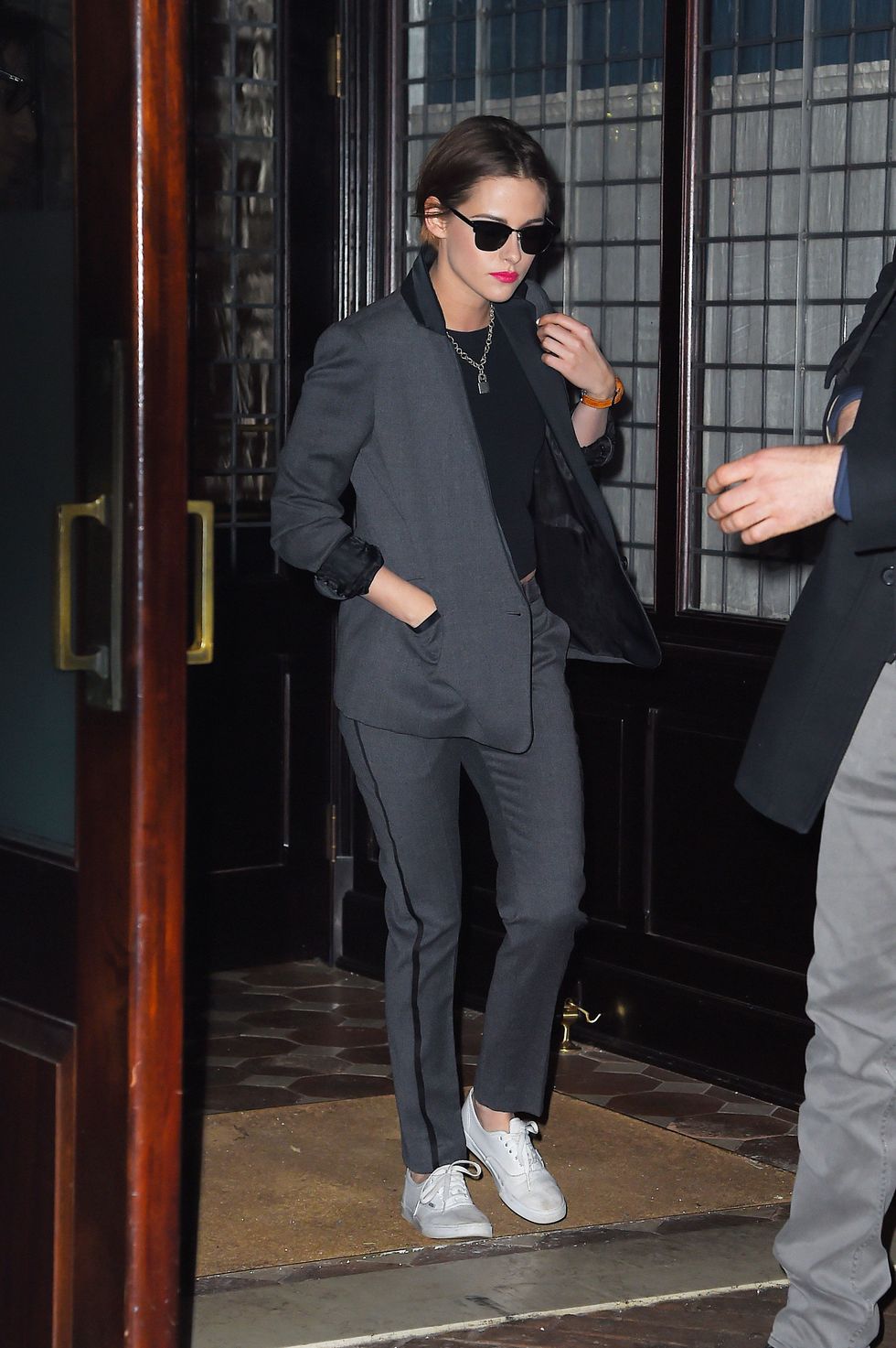 Kristen Stewart wearing a suit and trainers