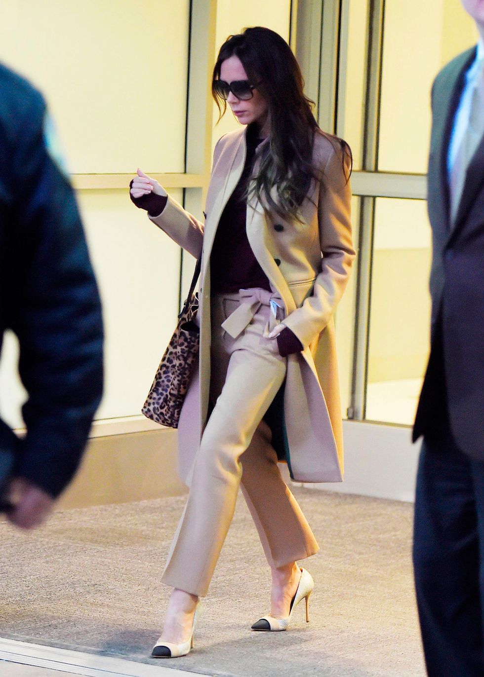 Victoria Beckham at JFK airport wearing camel